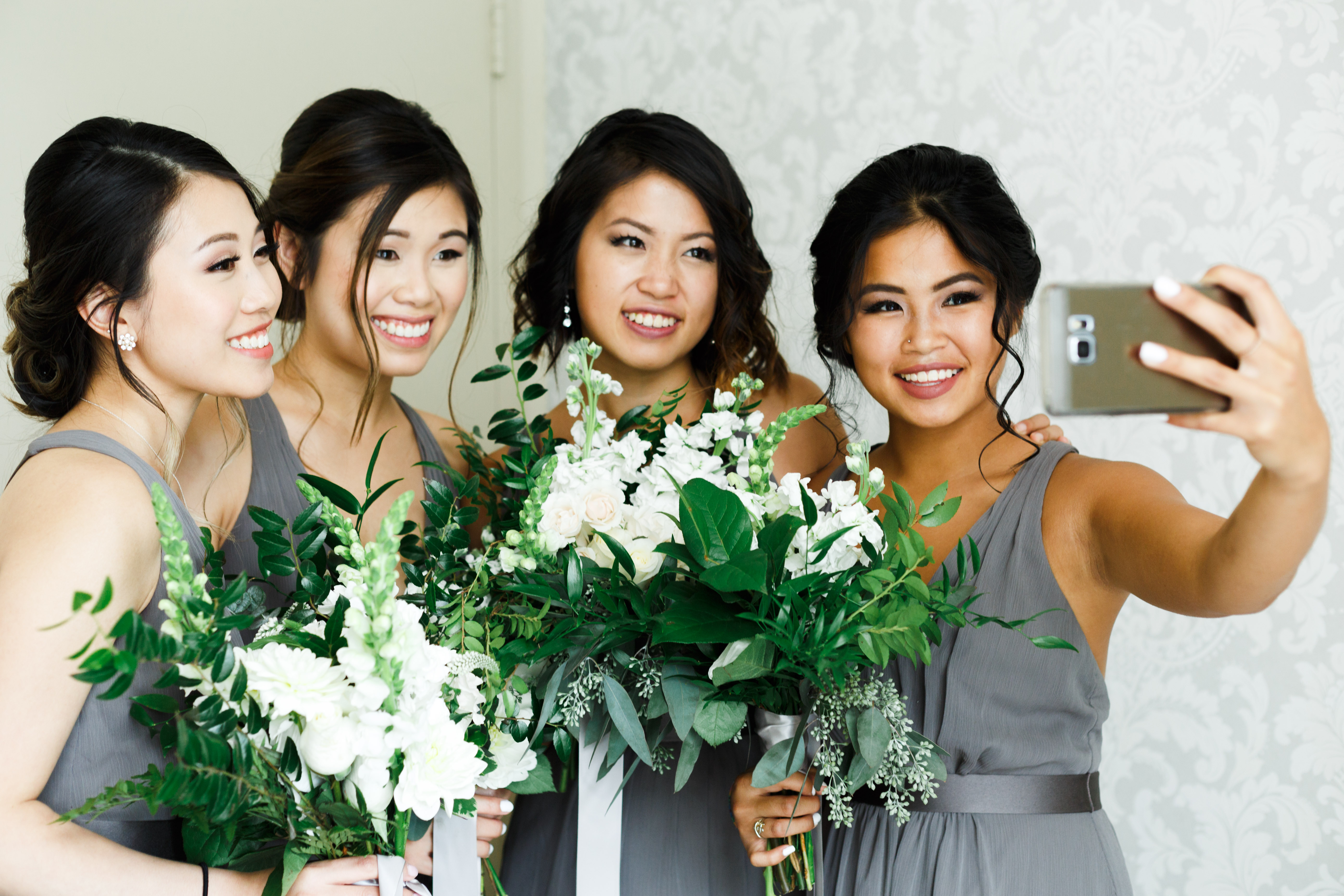 bridesmaids taking selfie at wedding
