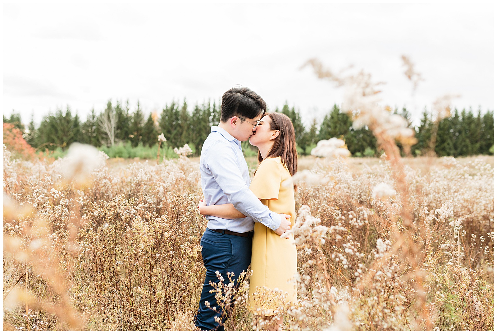 Kortright Centre Engagement Couple Kissing in Field
