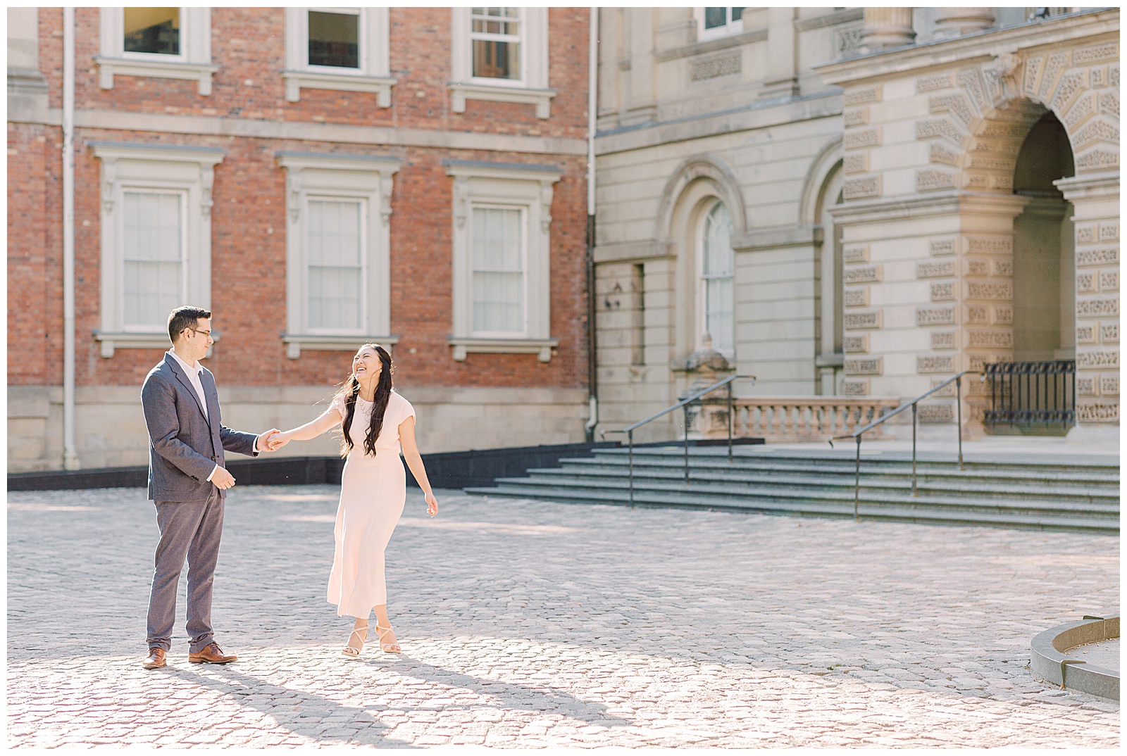 Osgoode Hall Summer Engagement Session - Couple twirling at Osgoode Hall